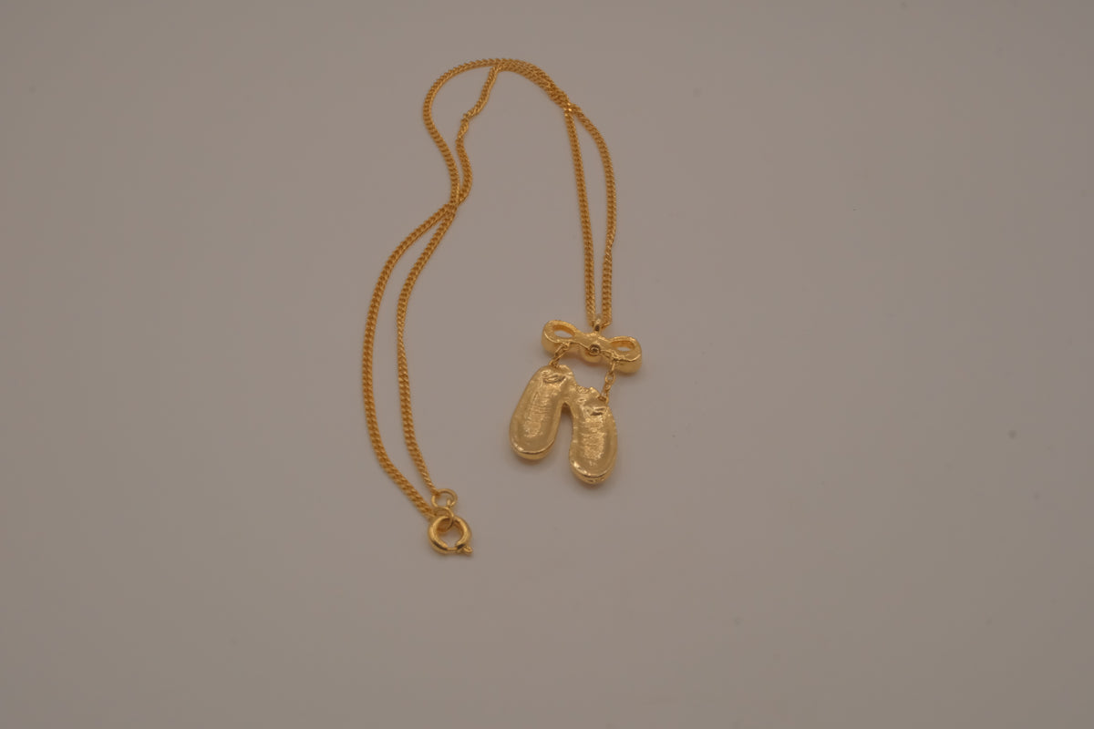 Gold toned ballet slipper pendant necklace