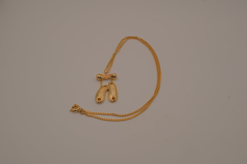 Gold toned ballet slipper pendant necklace