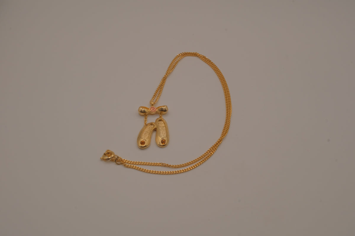 Gold toned ballet slipper pendant necklace
