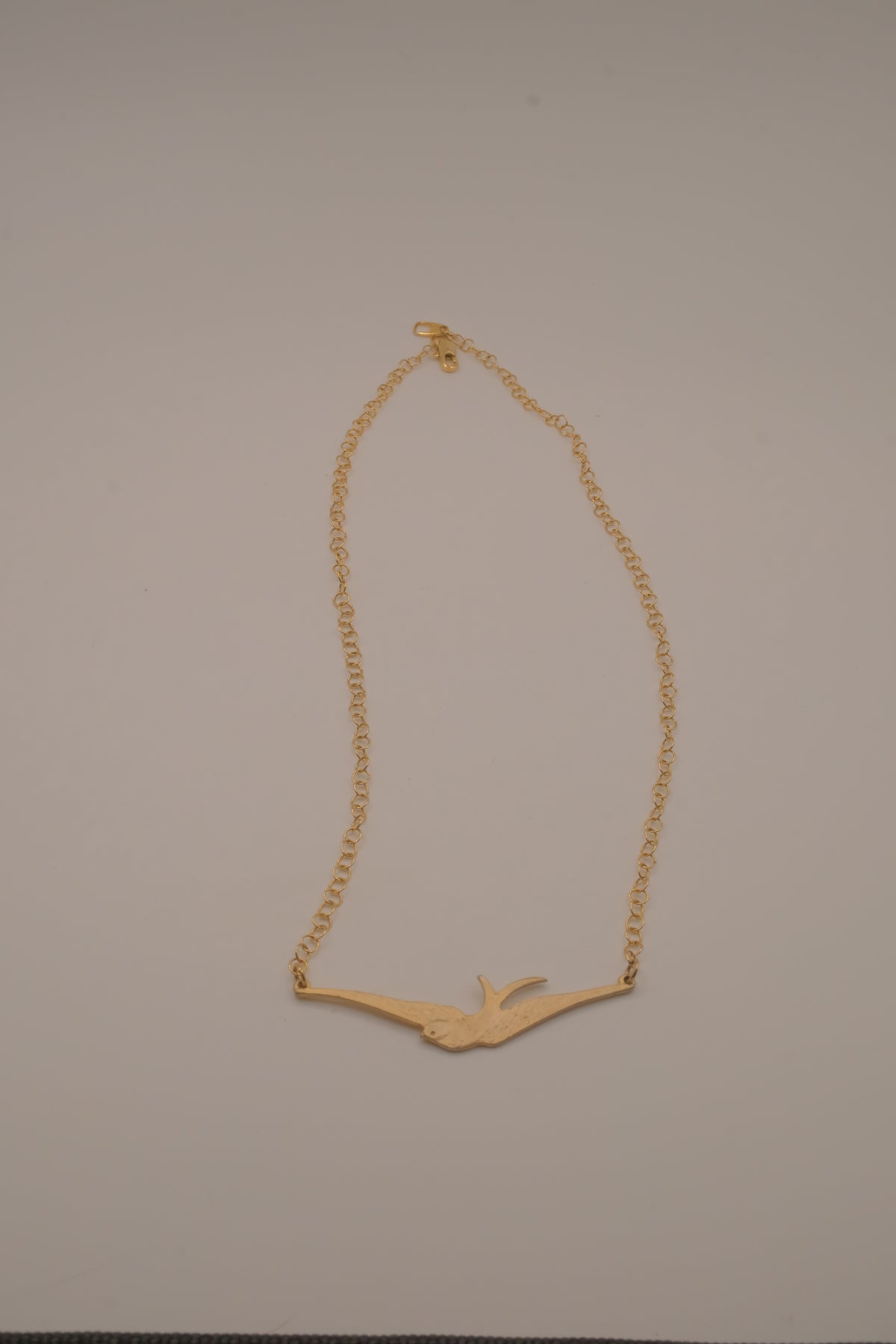 Horizontal flying bird necklace