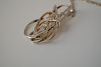 Modern intewined silver tone pendant necklace