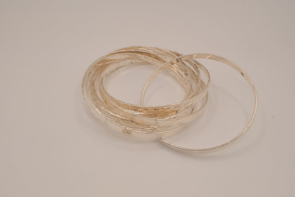 Silver tone rolling bangle bracelet