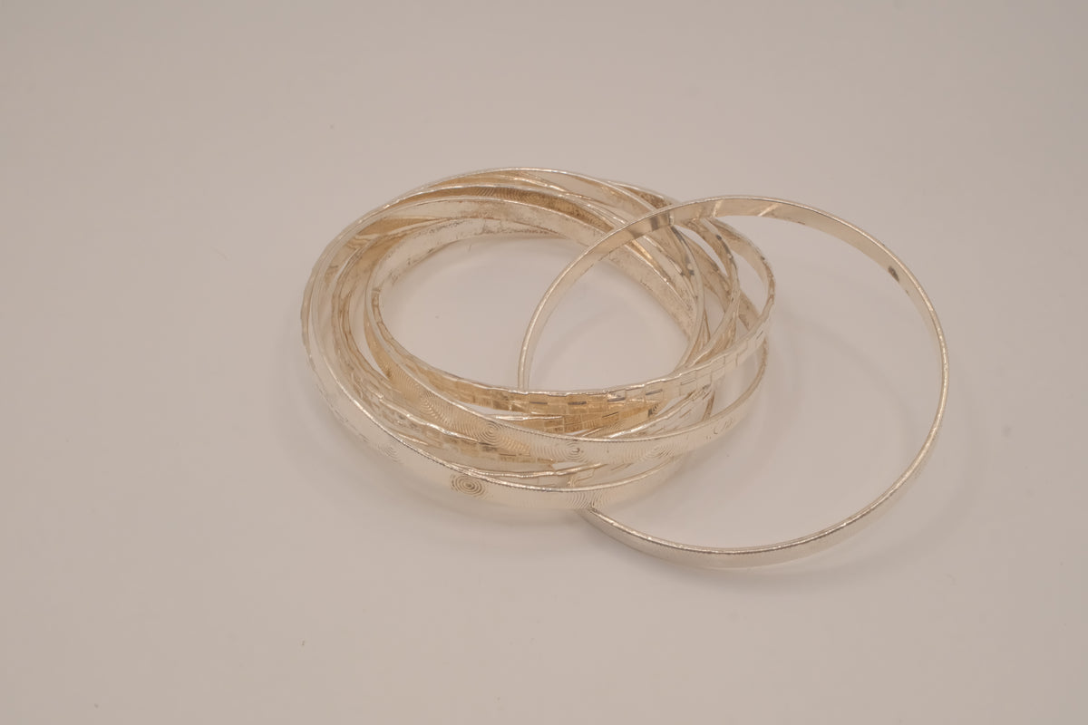 Silver tone rolling bangle bracelet