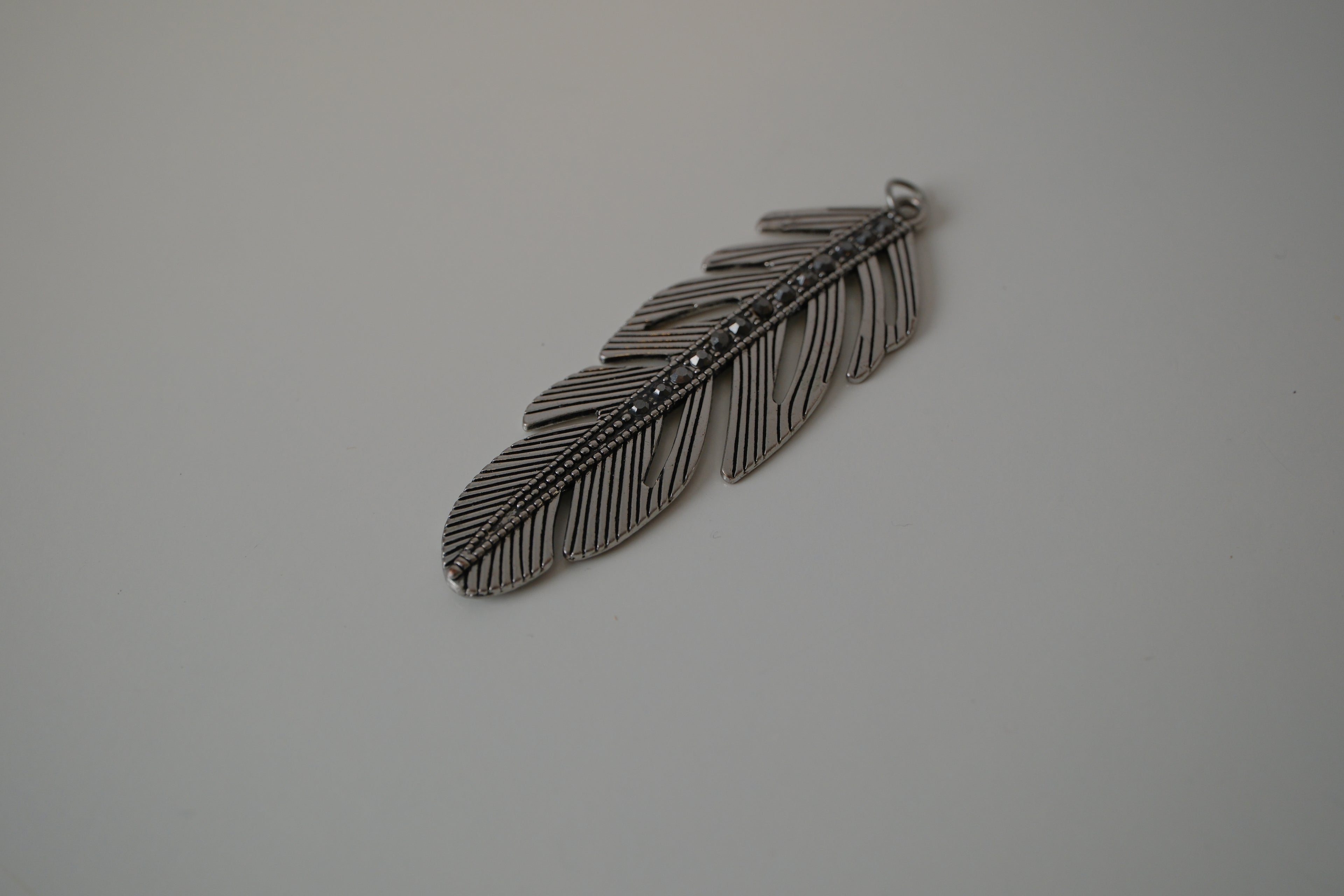 Vintage silver-toned feather pendant