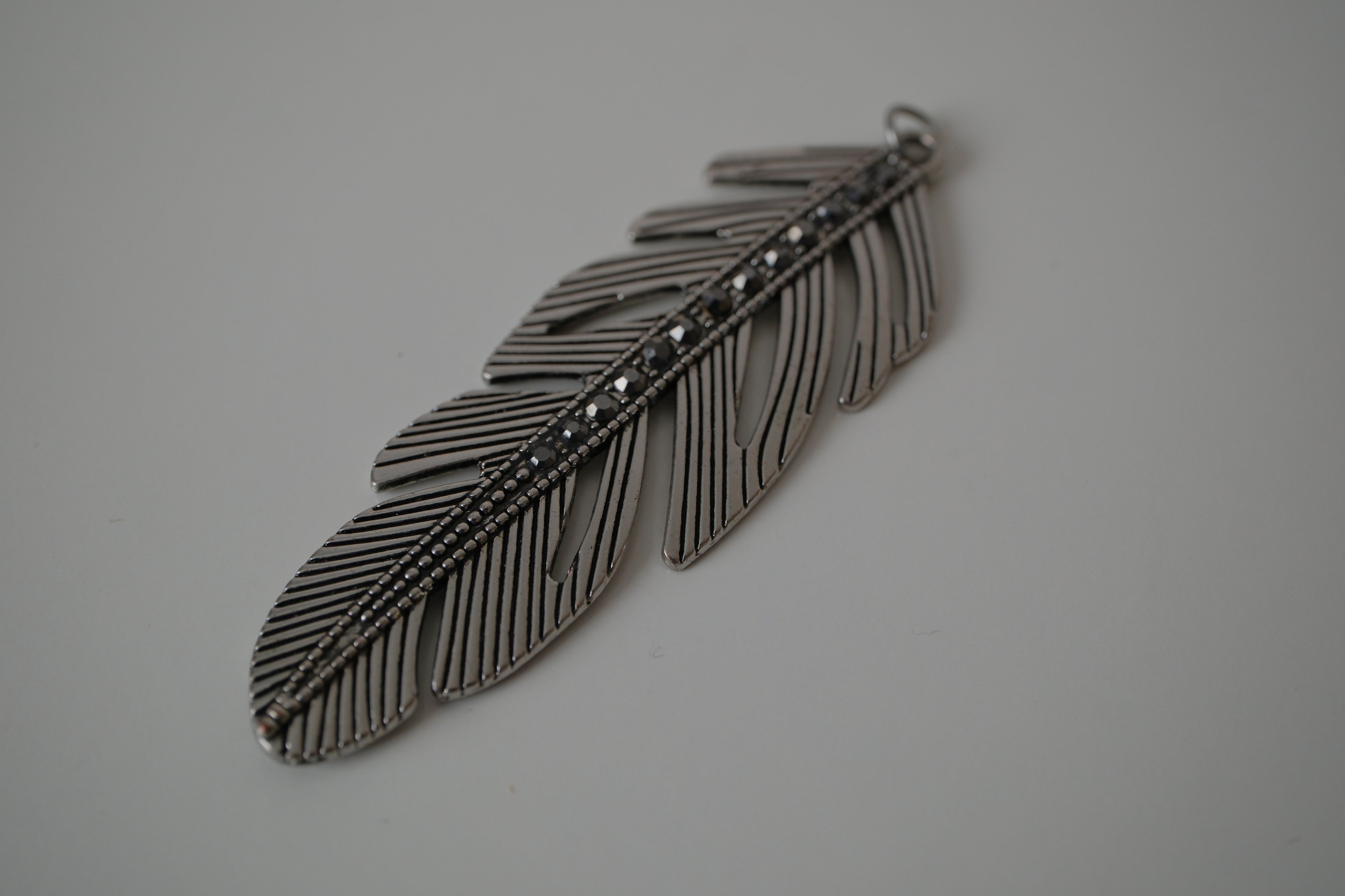 Vintage silver-toned feather pendant