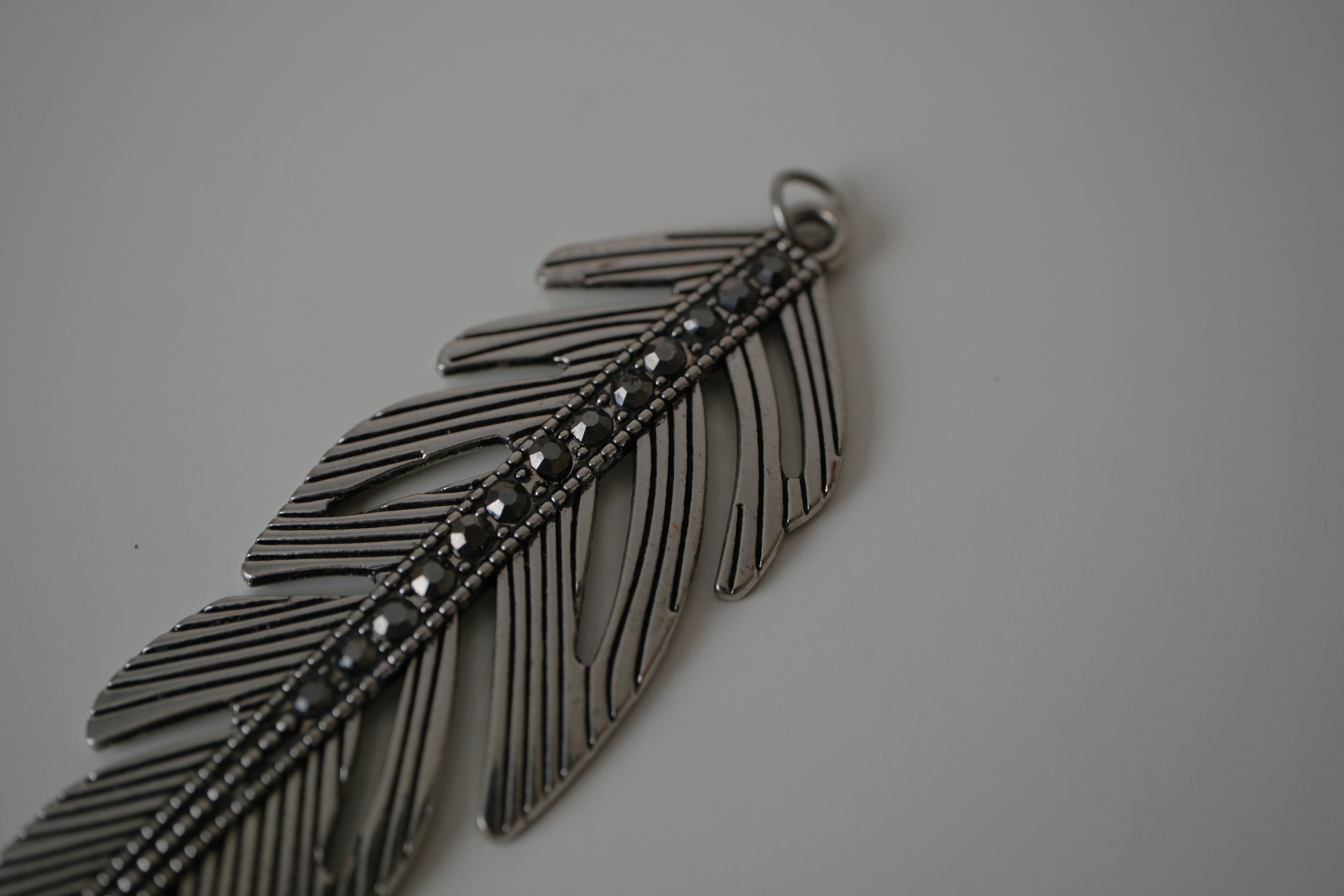 Vintage silver-toned feather pendant