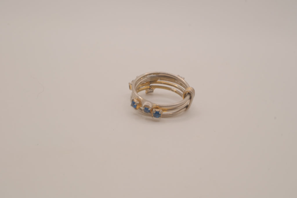 Vintage multi-band harem ring featuring blue stones