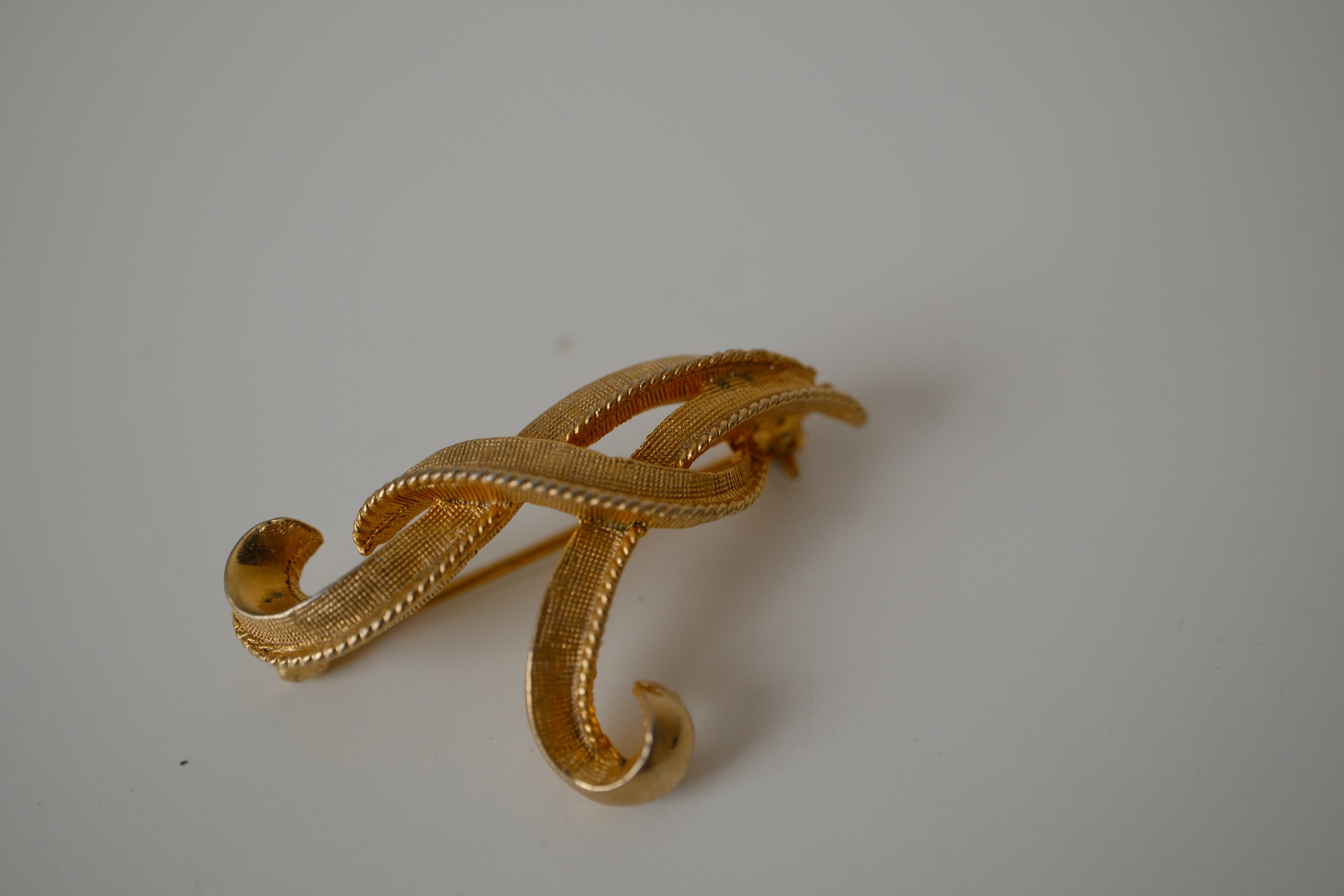 Vintage Coro gold-tone cursive letter "A" brooch