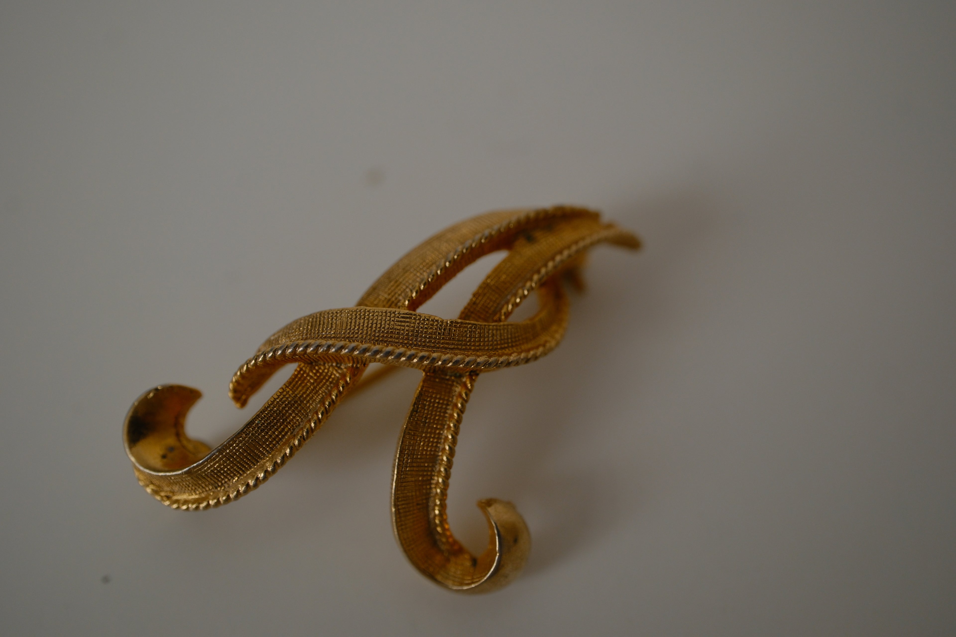 Vintage Coro gold-tone cursive letter "A" brooch