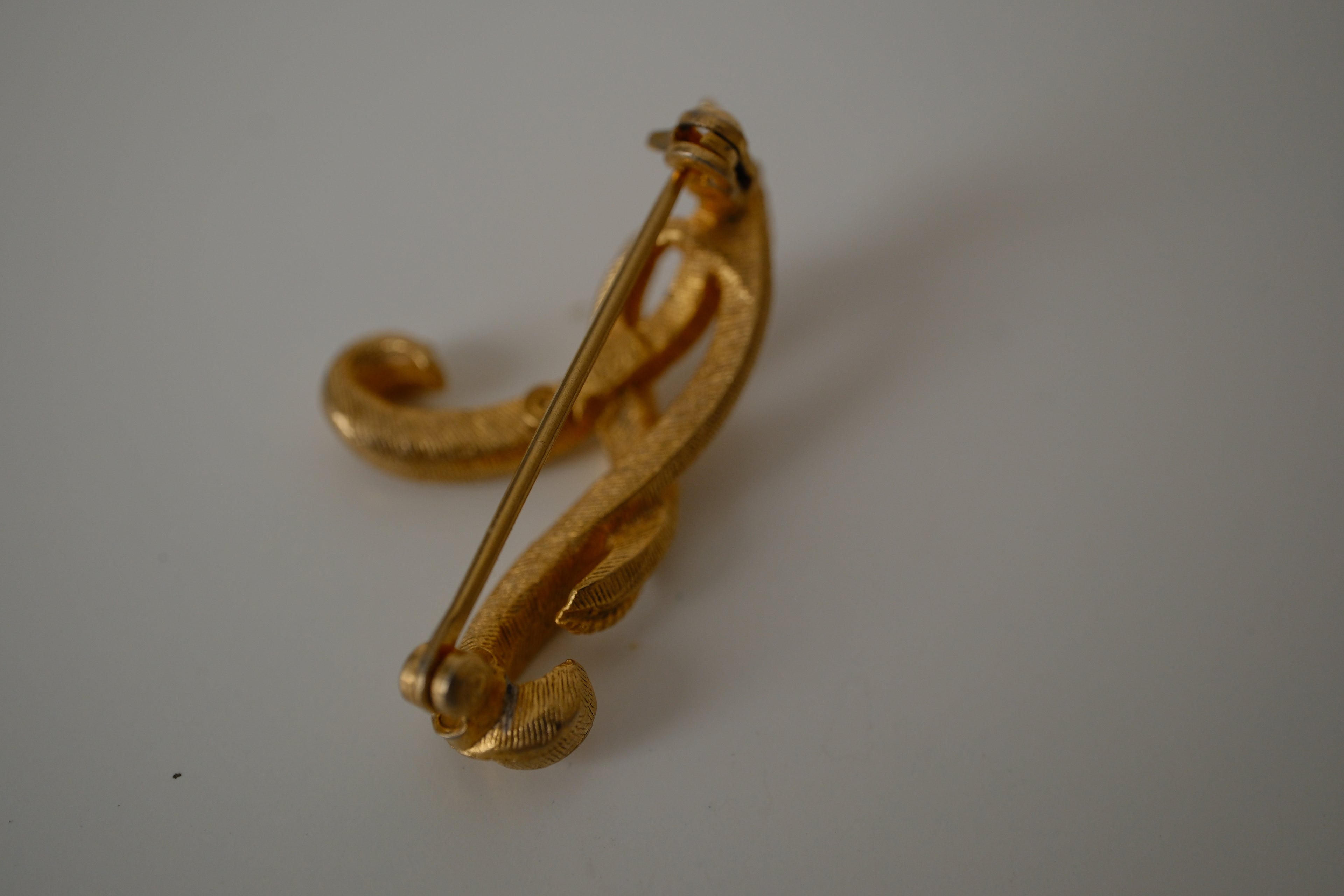 Vintage Coro gold-tone cursive letter "A" brooch