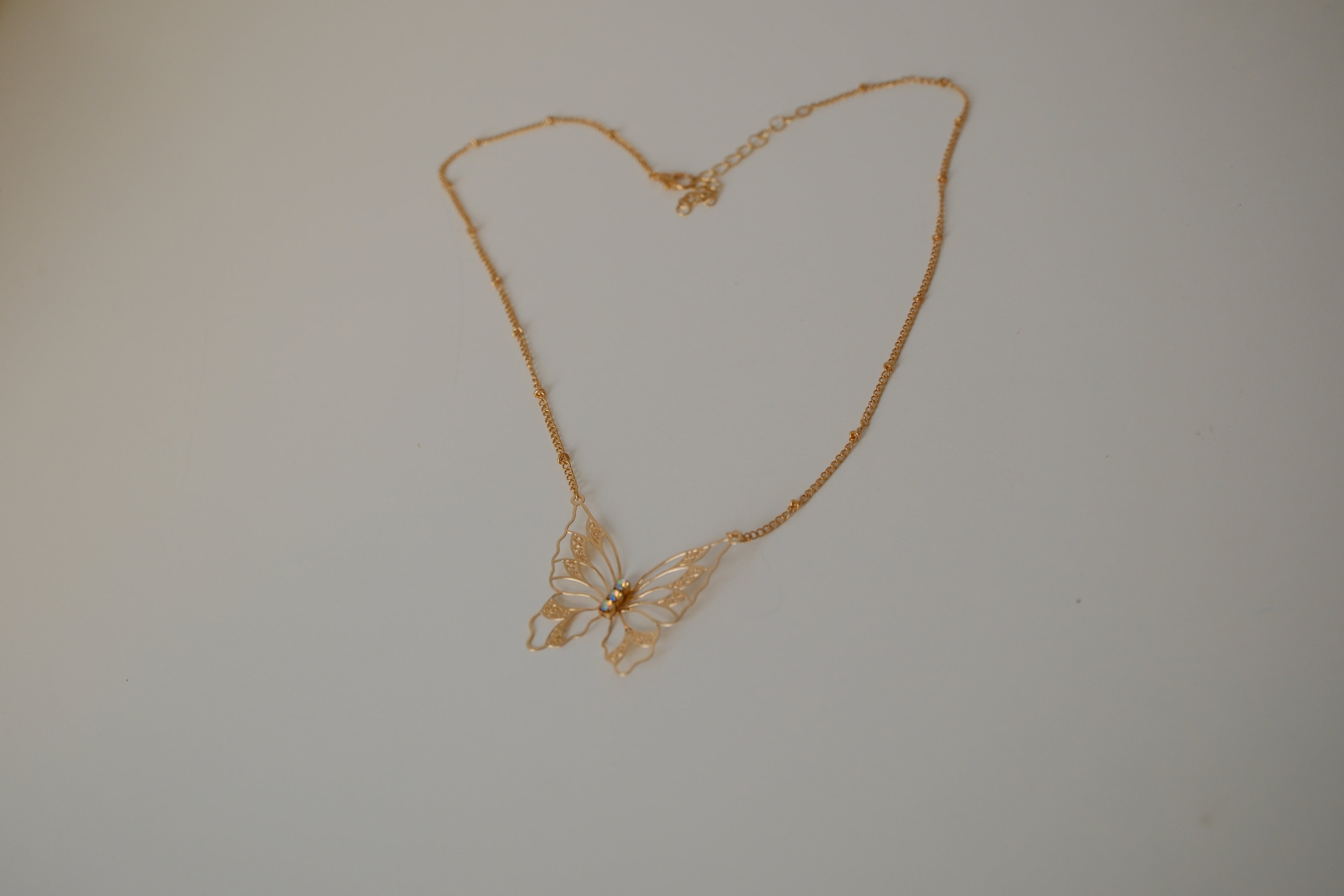 Gold butterfly filigree necklace