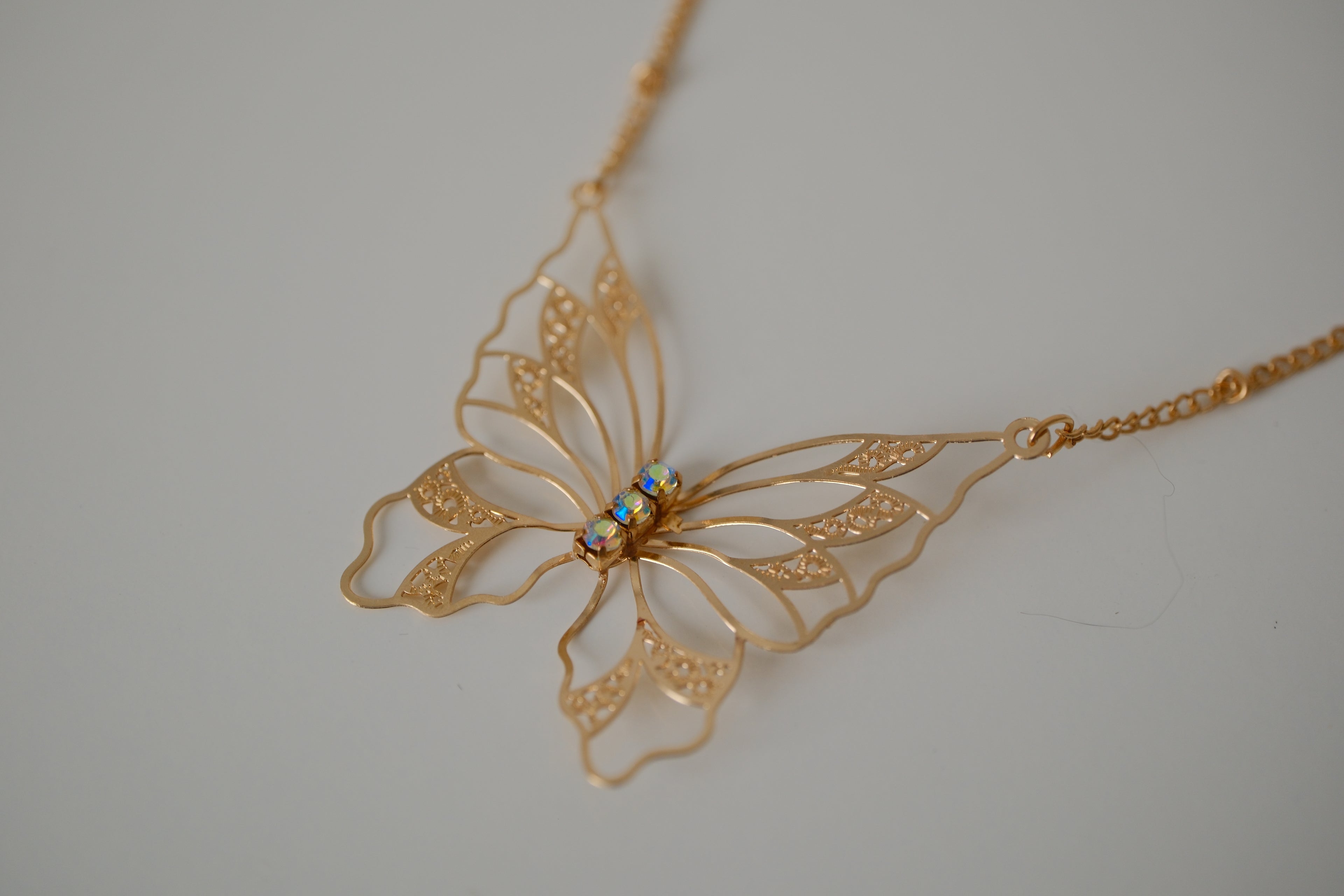 Gold butterfly filigree necklace