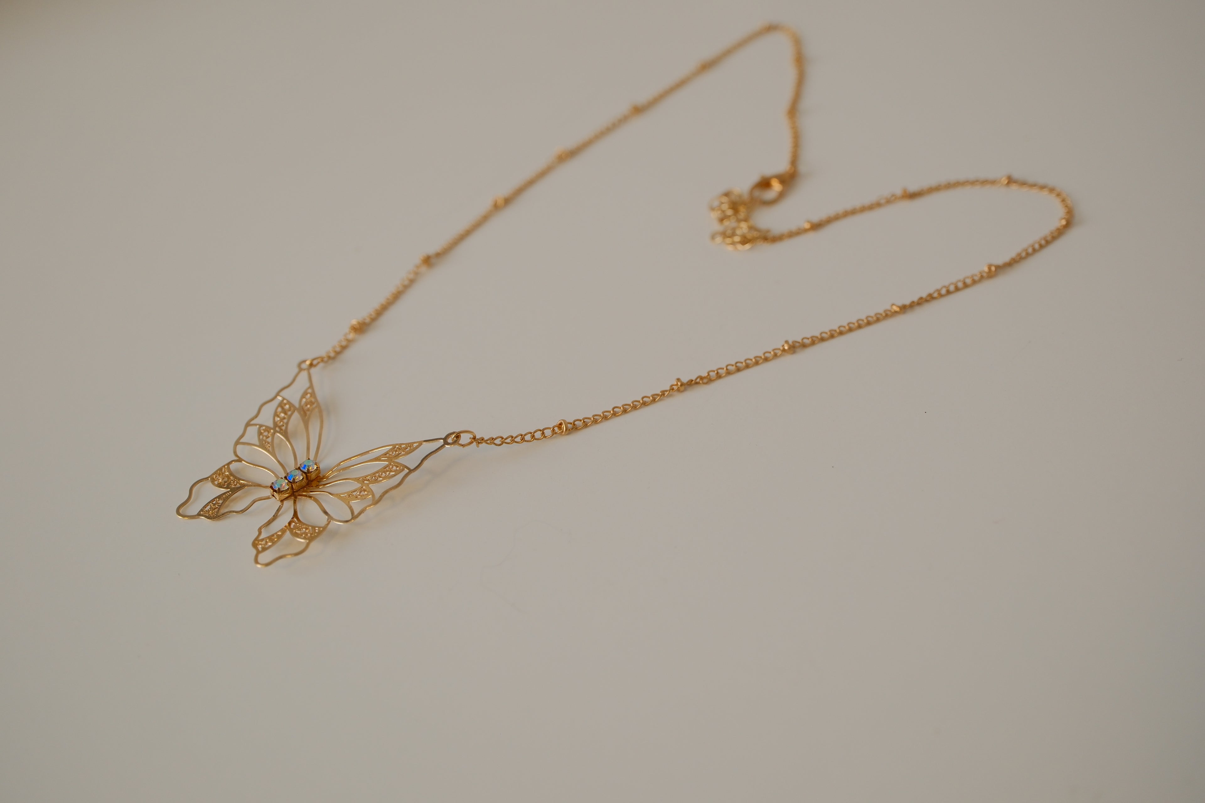 Gold butterfly filigree necklace
