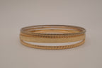 Set of 4 textured gold-tone stacking bangle bracelets