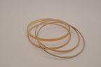 Set of 4 textured gold-tone stacking bangle bracelets