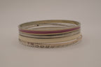 Set of 5 textured silver tone and enamel stacking bangle bracelets