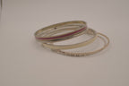 Set of 5 textured silver tone and enamel stacking bangle bracelets