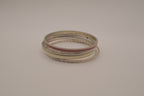 Set of 5 textured silver tone and enamel stacking bangle bracelets