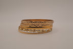 Set of 5 textured and engraved gold tone stacking bangle bracelets