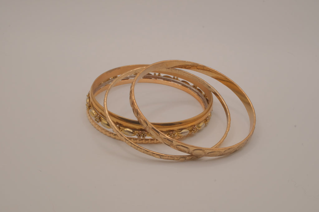Set of 5 textured and engraved gold tone stacking bangle bracelets