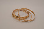 Set of 5 textured and engraved gold tone stacking bangle bracelets