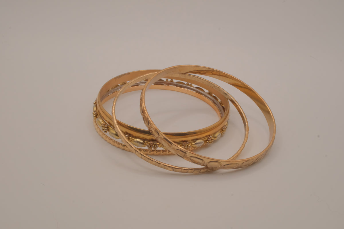 Set of 5 textured and engraved gold tone stacking bangle bracelets
