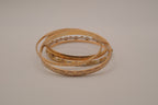 Set of 5 textured and engraved gold tone stacking bangle bracelets