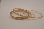 Set of 6 textured and floral gold-tone bangles