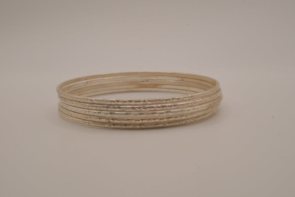 Set of 5 thin, textured silver tone bangle bracelets