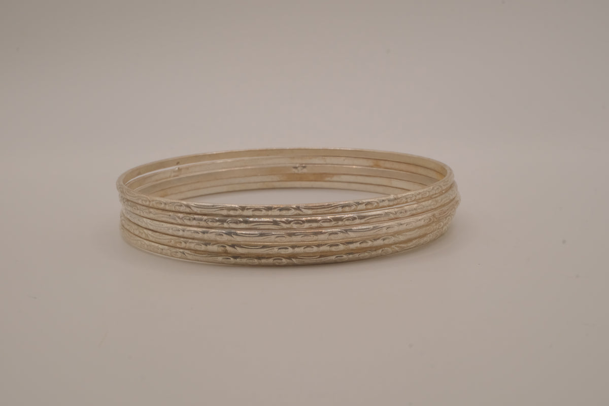 Set of 5 thin, textured silver tone bangle bracelets