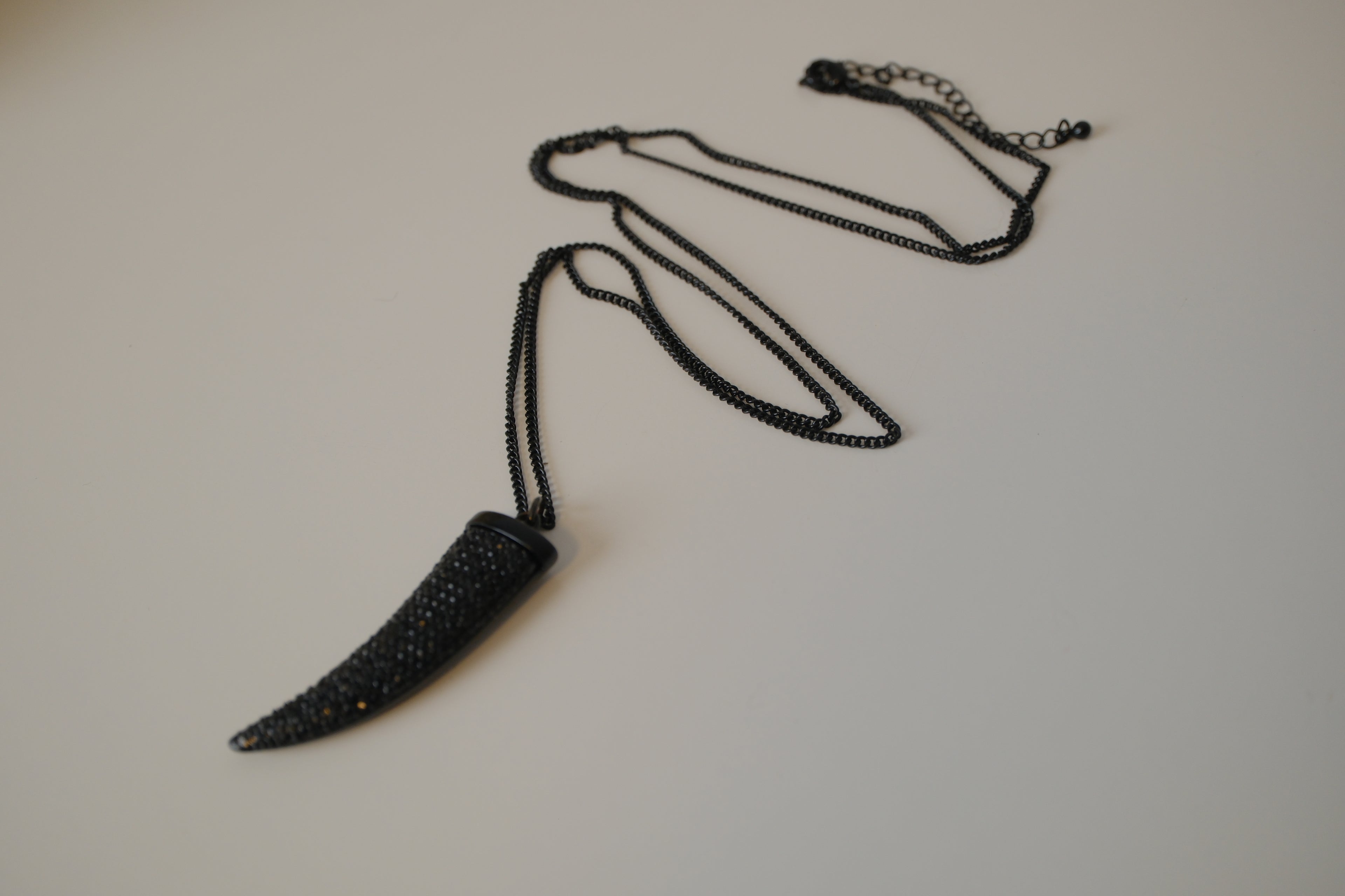Black pave-encrusted horn/tooth pendant necklace