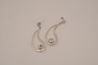 Silver tone teardrop open-frame dangle earrings