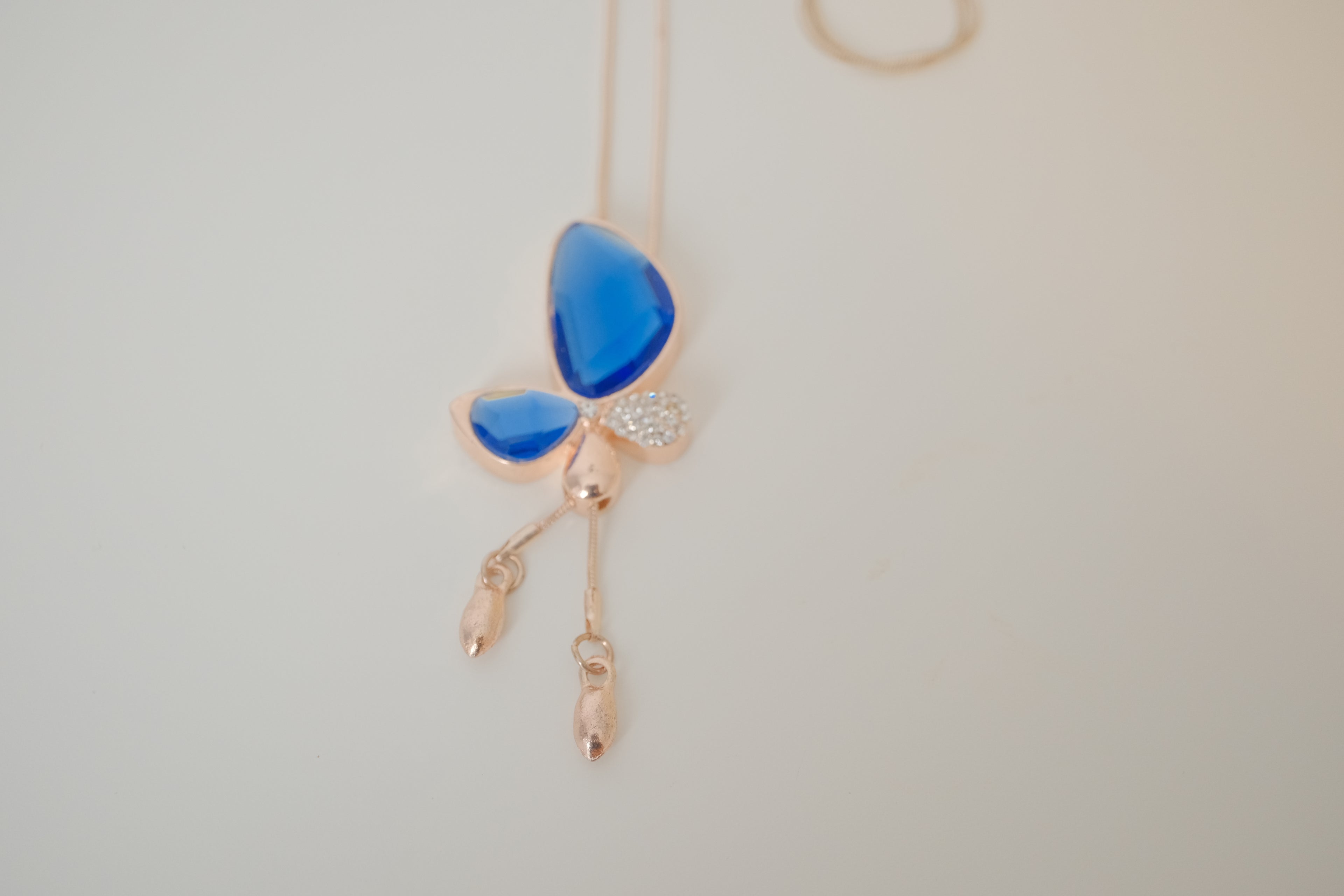 Blue crystal butterfly pendant on Rose Gold chain