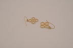 Gold tone interlocking clover drop earrings