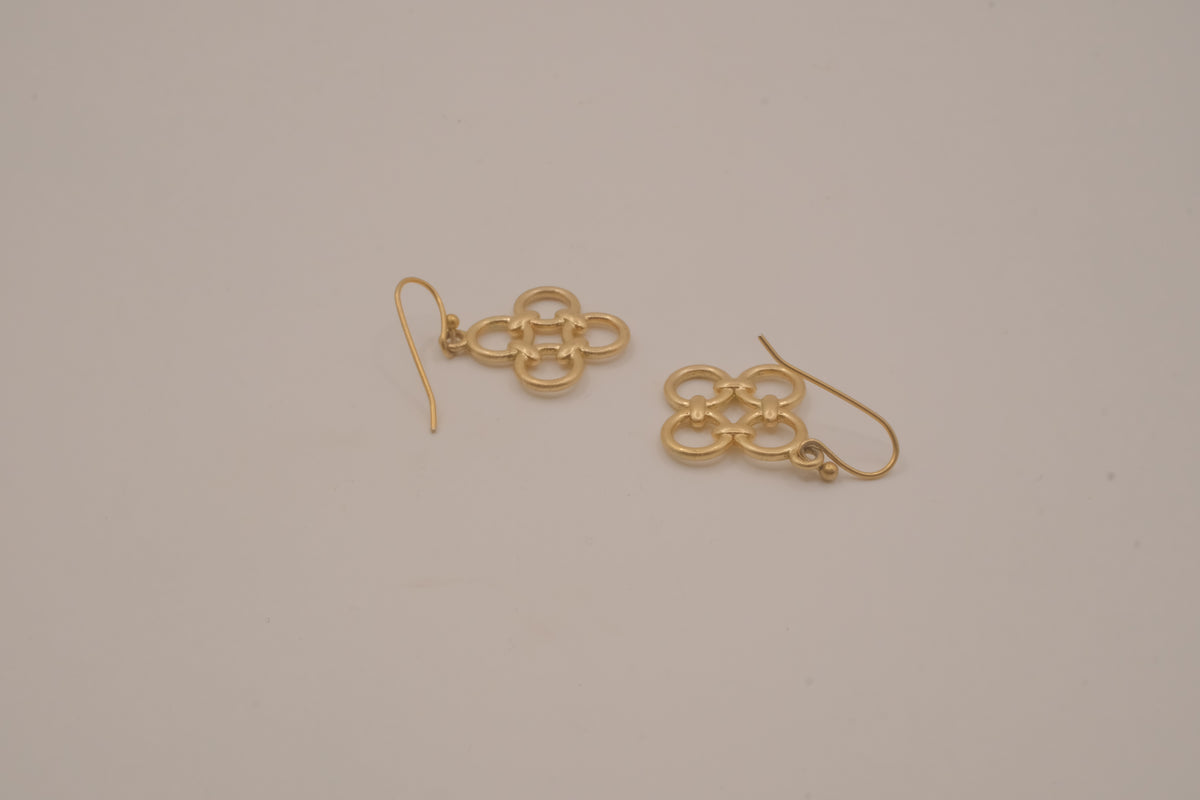 Gold tone interlocking clover drop earrings