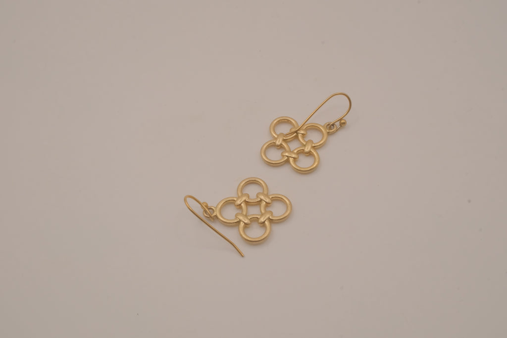 Gold tone interlocking clover drop earrings