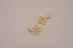Gold tone interlocking clover drop earrings
