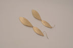 Hammered gold tone double-leaf dangle earrings