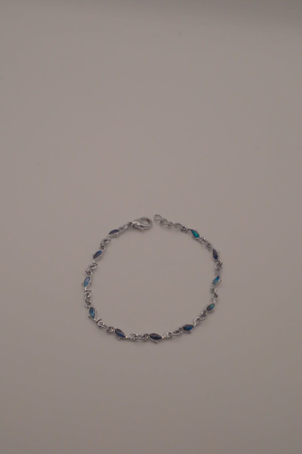 Dainty dolphin-link charm bracelet with Abalone inlay