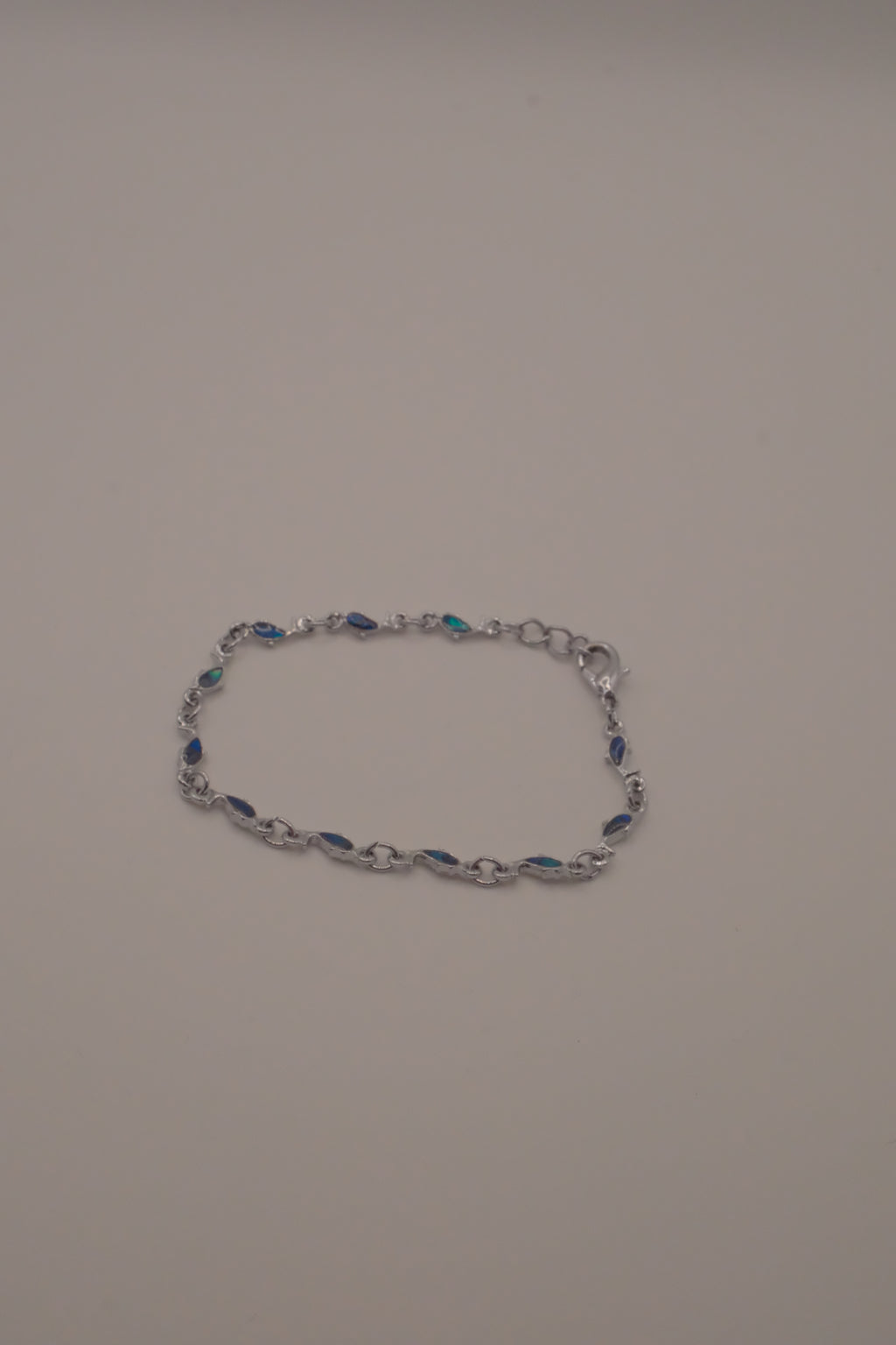 Dainty dolphin-link charm bracelet with Abalone inlay