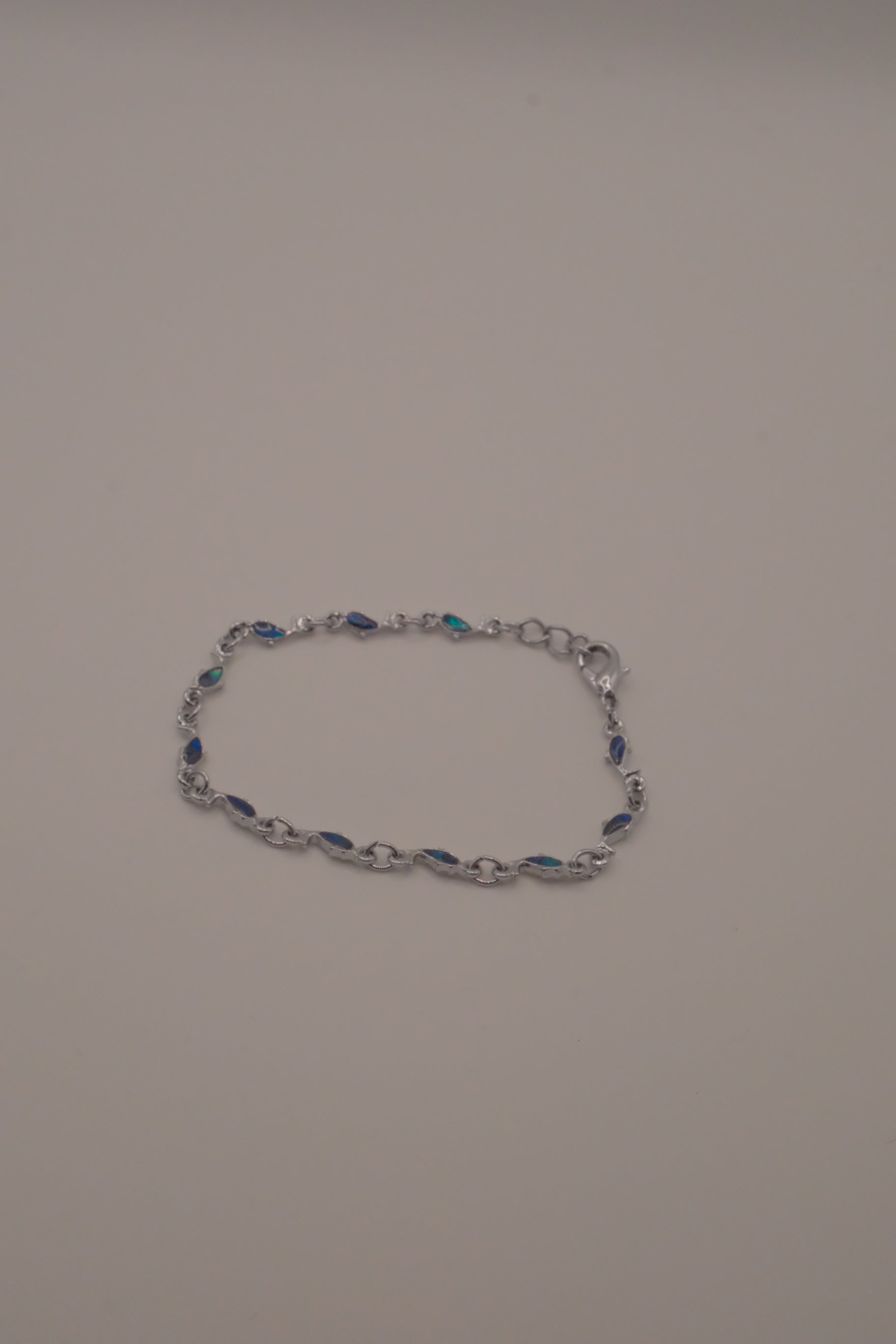 Dainty dolphin-link charm bracelet with Abalone inlay