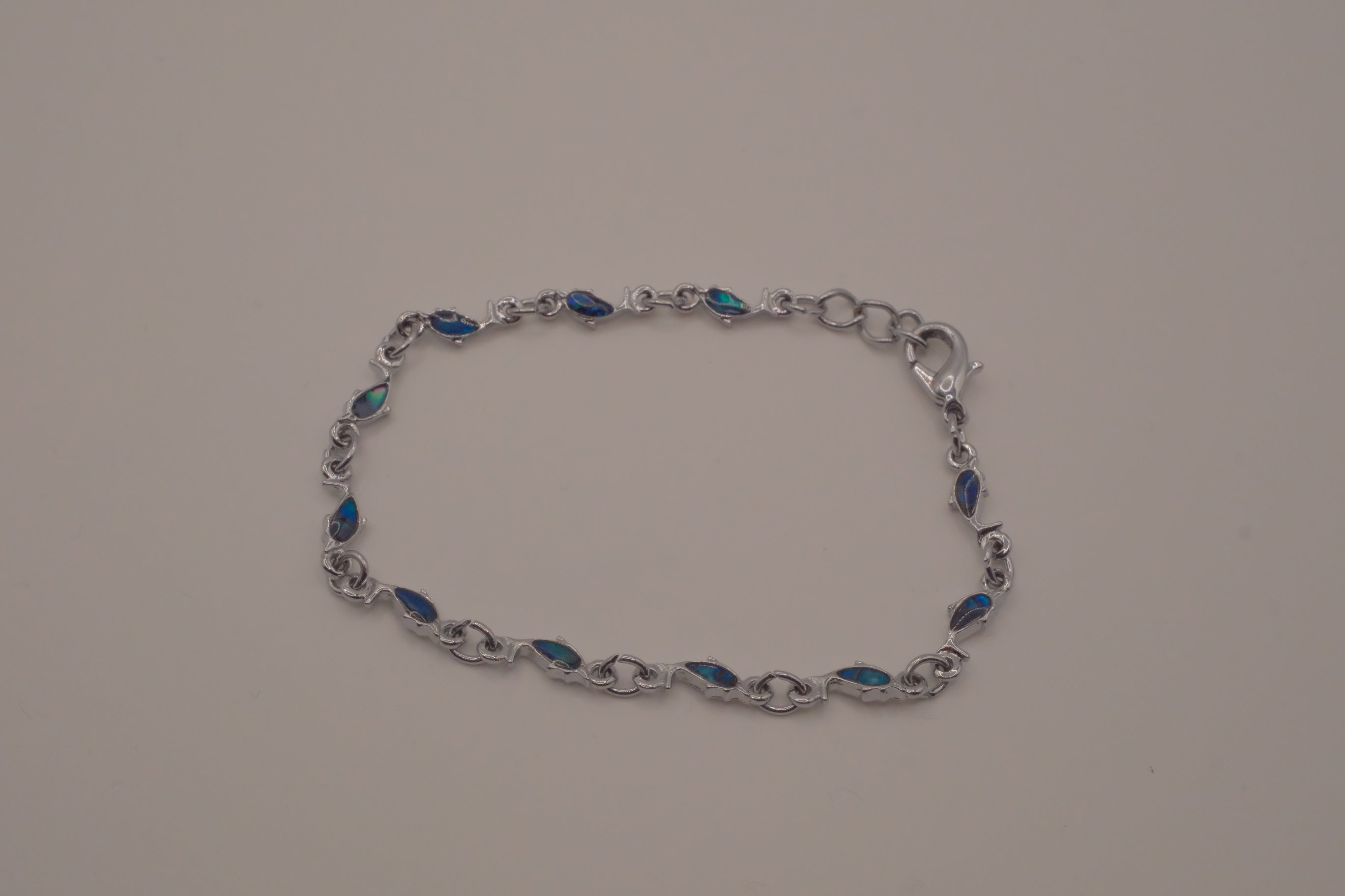 Dainty dolphin-link charm bracelet with Abalone inlay