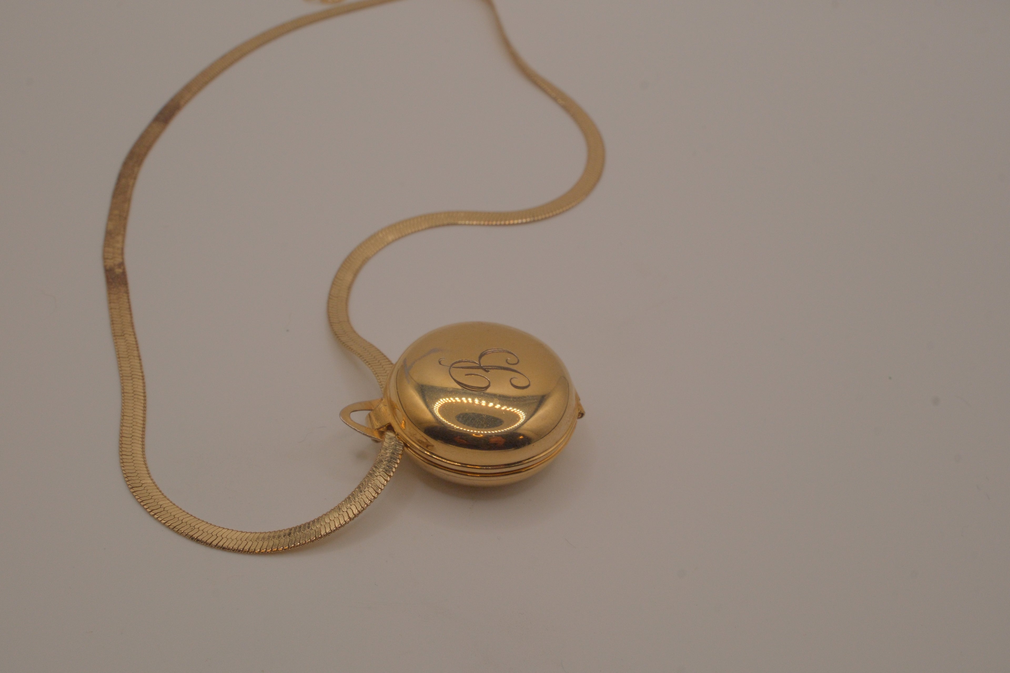 Antique round pocket watch-style locket