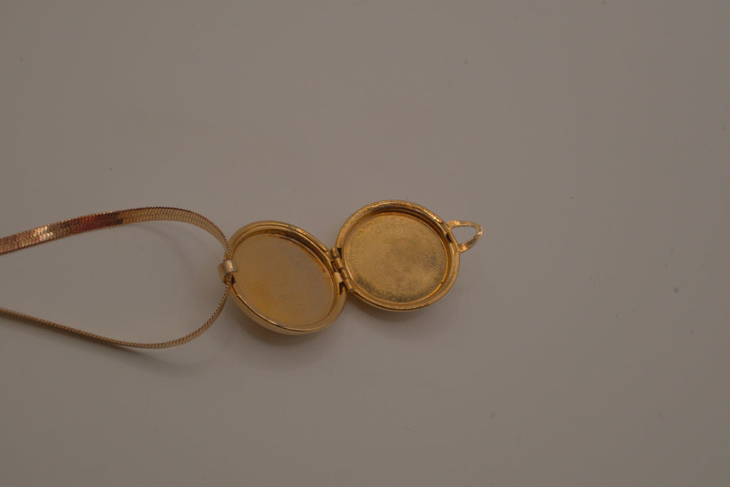 Antique round pocket watch-style locket