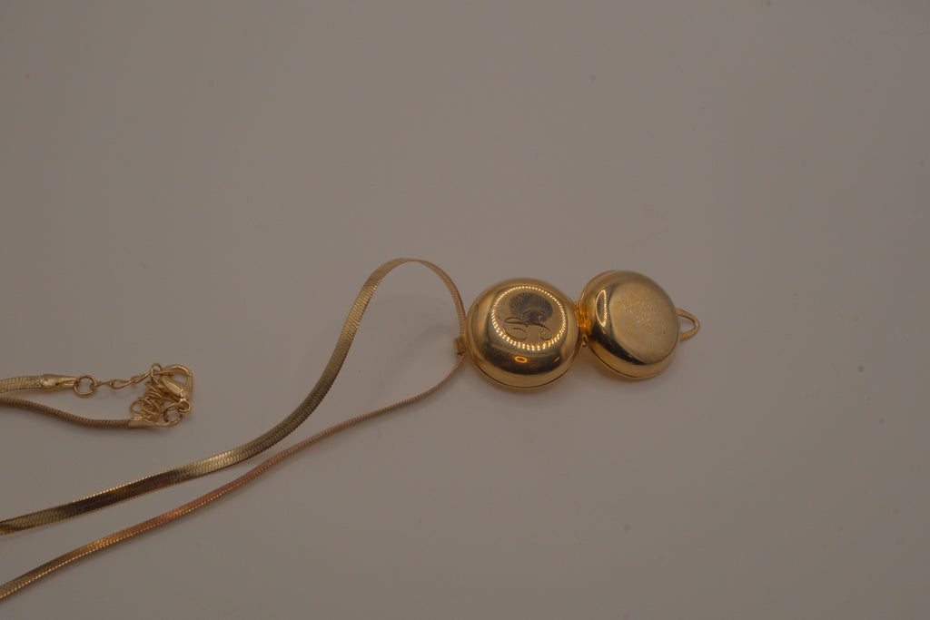 Antique round pocket watch-style locket