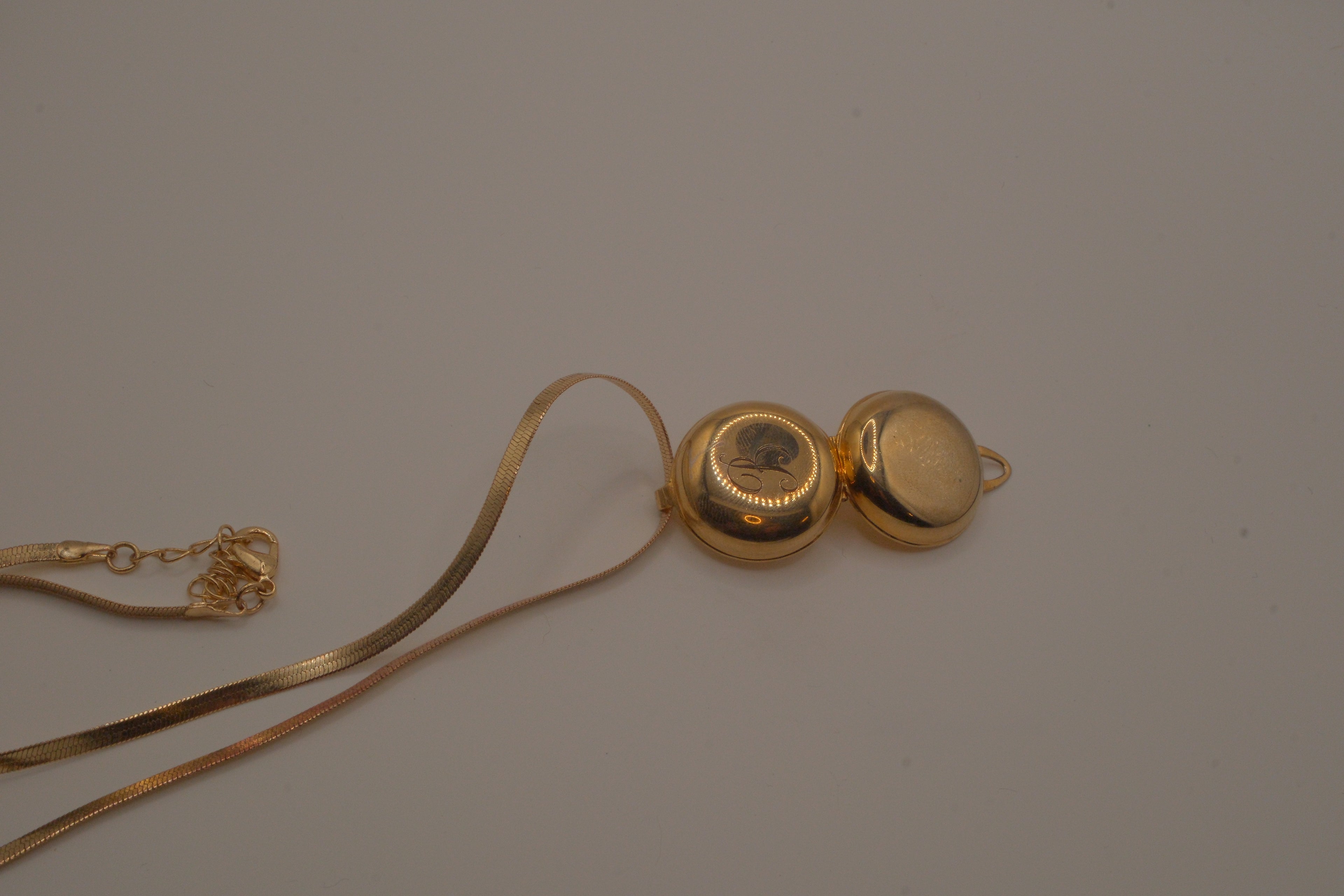 Antique round pocket watch-style locket