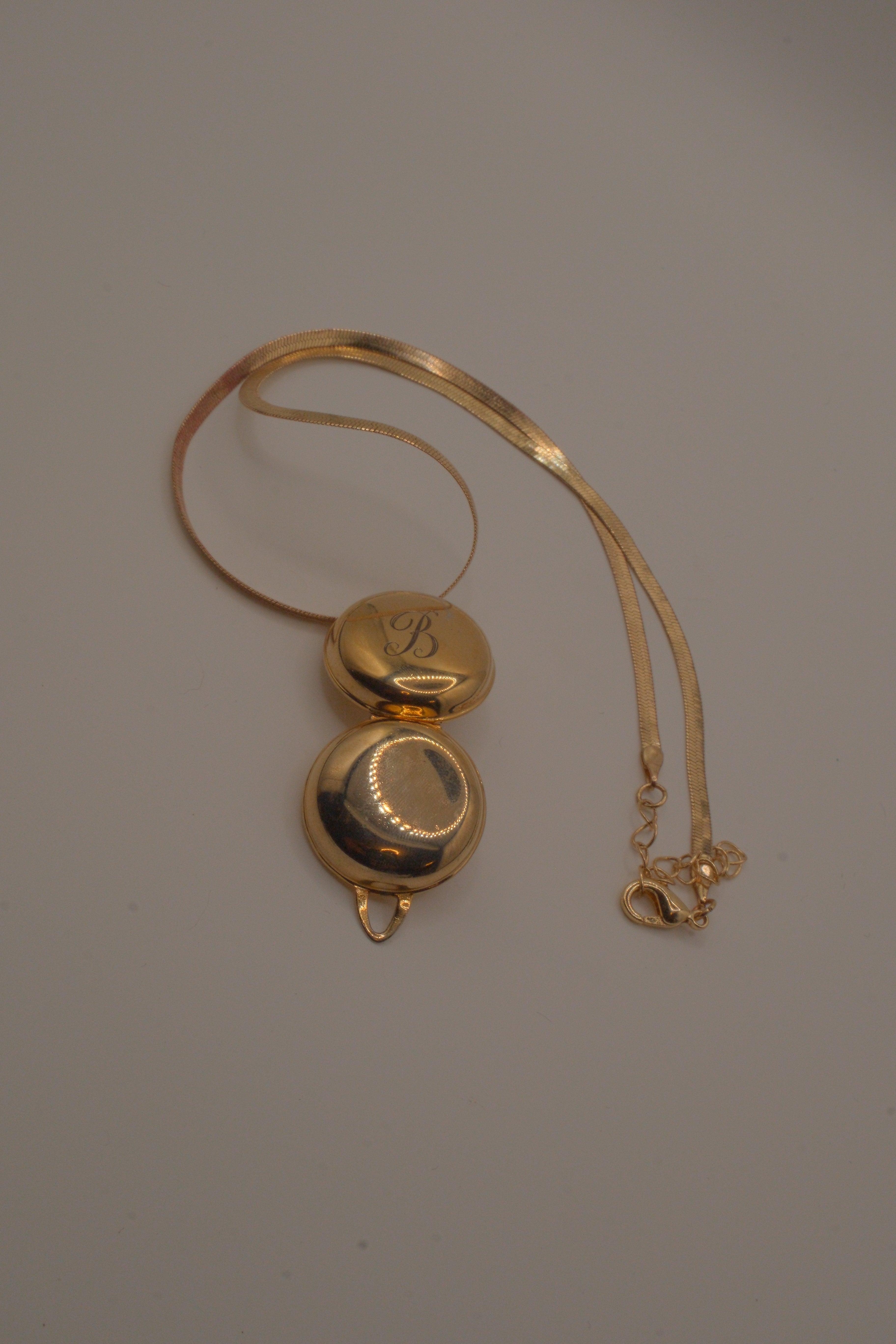 Antique round pocket watch-style locket