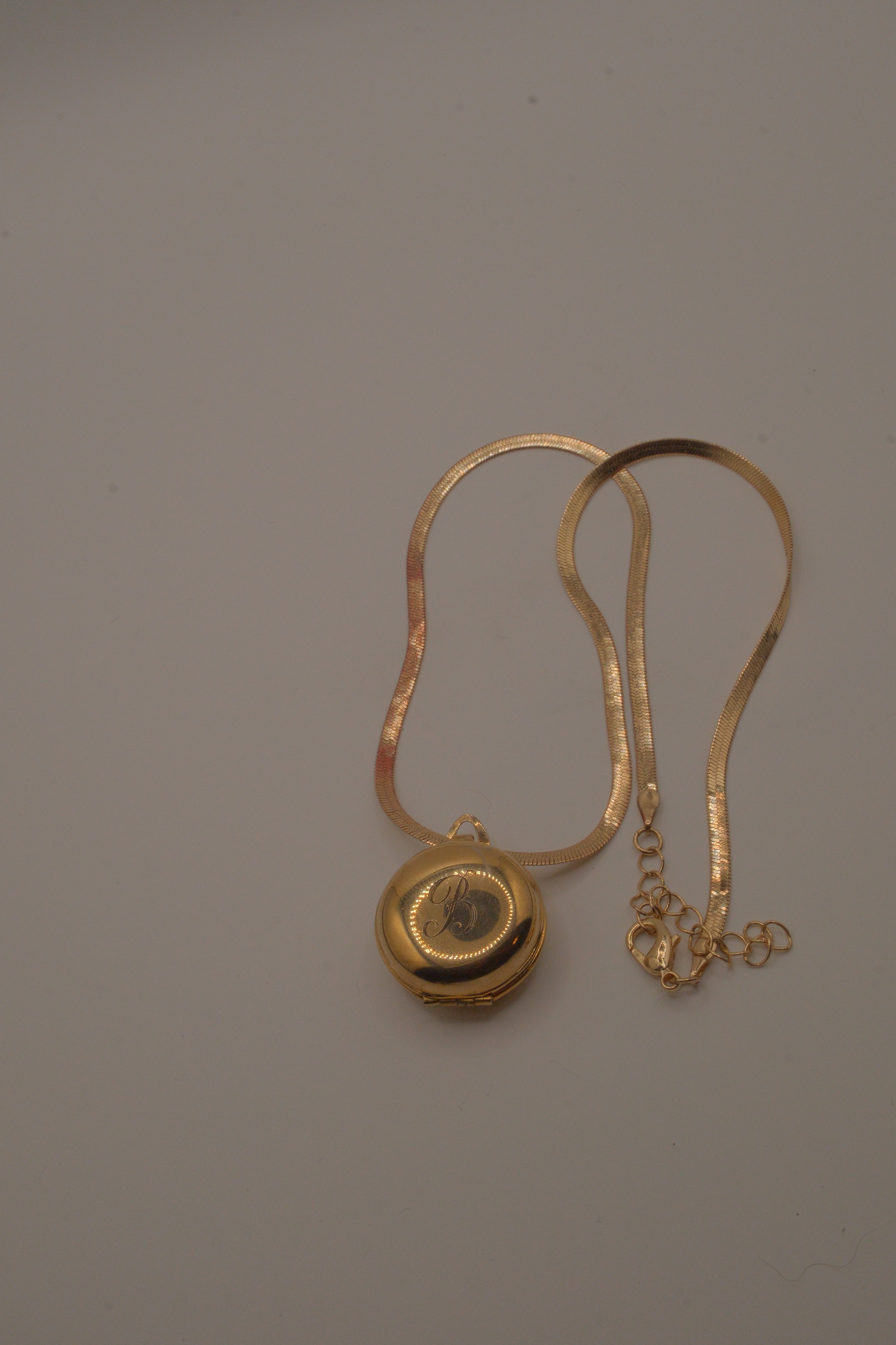 Antique round pocket watch-style locket