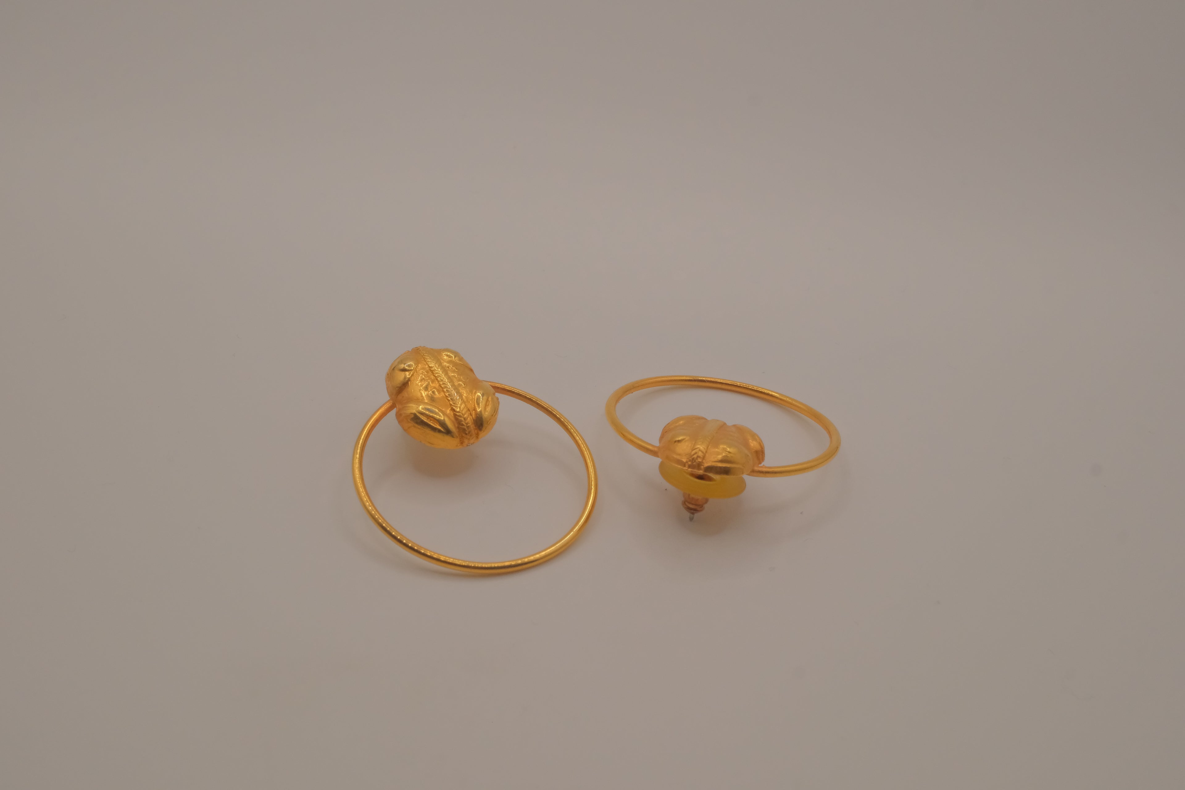 Artisanal gold hoop earring