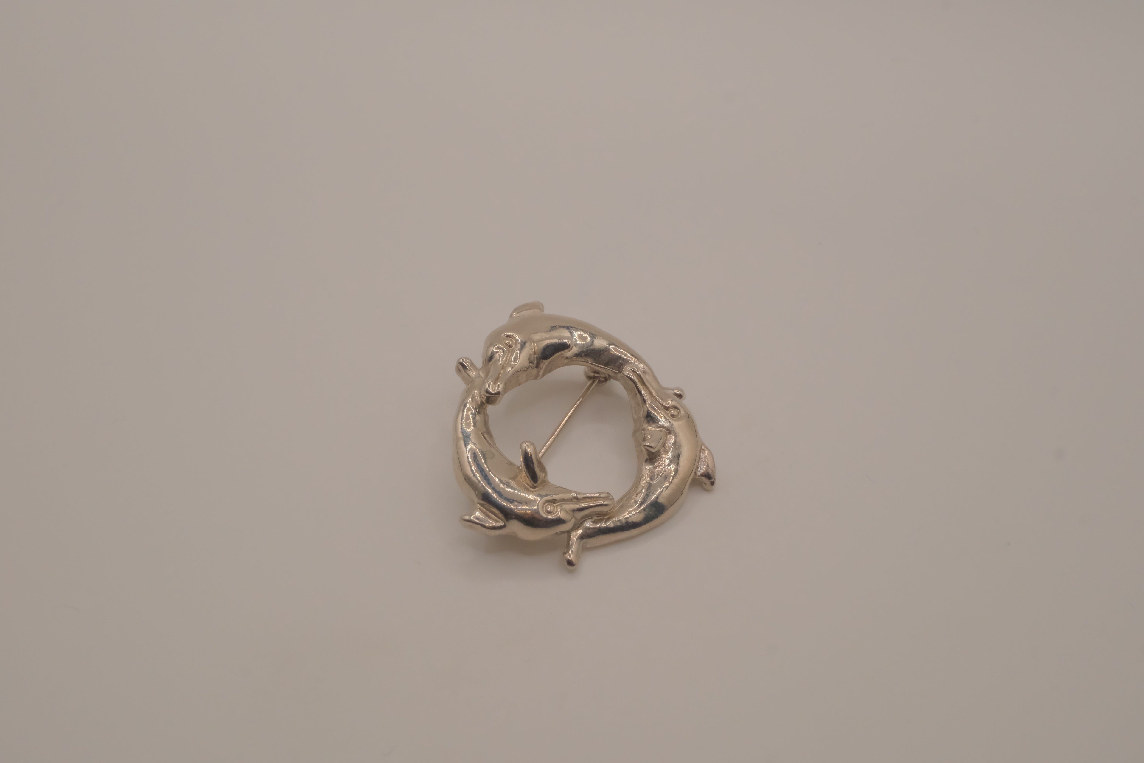 Vintage silver dolphin circle brooch
